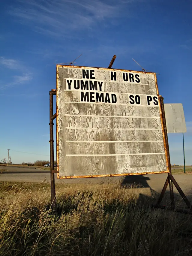Roadside sign for the Hen House Cafe